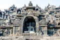 Multiple ancient stone sculptures of Buddha on the relief in Borobudur Temple in Yogyakarta, Java, Indonesia. Royalty Free Stock Photo