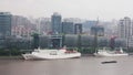 Multiple barges sailing along river through Shanghai. Shanghai, China