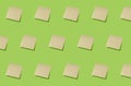 Multiple blank stick notes on green background