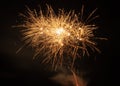 multiple bright white and yellow fireworks at night festival