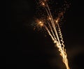 multiple bright yellow spiral fireworks at night