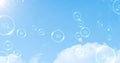 Multiple bubbles with 5g text floating and bursting against clouds in blue sky