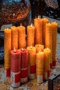 Multiple candles with flames inside temple in Ho Chi Minh city