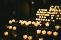 Multiple candles light in a row in Strasbourg Notre-Dame cathedral