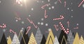 Multiple candy cane icons falling over multiple christmas tree icons on grey background Royalty Free Stock Photo