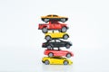 Multiple car toys on top of each other suggesting automotive industry problems