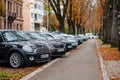 Multiple cars parked in public parking in row cars and cycling lane