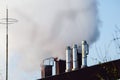 Multiple coal fossil fuel power plant smokestacks emit carbon dioxide pollution of environment and air