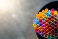 Multiple color drinking straws in a glass bottlebackground blur Royalty Free Stock Photo