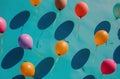 multiple colored balloons are on a blue background,