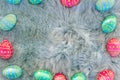 Chocolate Easter eggs on fur, pink, blue and green eggs, easter backgroung