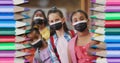Multiple colored pencils against group of diverse kids wearing face masks standing in a queue Royalty Free Stock Photo