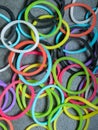 Multiple colored rubberbands in a pile on a gray textured background Royalty Free Stock Photo