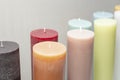 multiple colored thick candles, on gray background