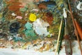 Multiple colors , Palette knives and brushes placed on the palette. Royalty Free Stock Photo