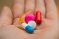 Multiple colors pills in young hand , Taking Your Medication Royalty Free Stock Photo