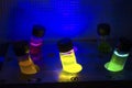Multiple colourful light induced catalyst photochemical reaction in glass vial under UV light in a dark chemistry laboratory