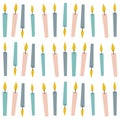 Multiple colourful lit candles in rows over white background