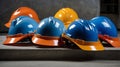 Multiple construction helmets of various colors placed together on a concrete surface in outdoor setting Royalty Free Stock Photo