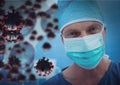 Multiple covid-19 cells against portrait of male surgeon wearing face mask