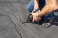 Repairing cracks in driveway with asphalt crack filler