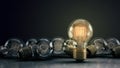Multiple 3D Illustrated Incandescent Light Bulbs on a Reflective Surface