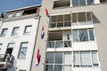 Multiple dutch flags on a facade of apartments