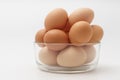 Multiple eggs in glass bowl on a white background