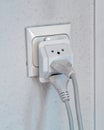 Multiple electrical plugs in wall outlet