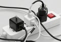 Multiple electronic devices powering up using a surge protector and extension cord hub Royalty Free Stock Photo