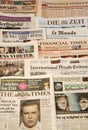 Multiple European newspapers in a pile