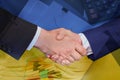 Multiple exposure of documents, business partners shaking hands and Ukrainian national flag