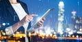 Multiple exposure of female programmer with tablet, digital binary code and night city. Royalty Free Stock Photo