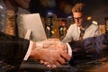 Multiple exposure of partners shaking hands, man working in office and cityscape. Business corporation Royalty Free Stock Photo