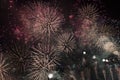 Multiple Fireworks in night sky in a composition in shades gold and red Royalty Free Stock Photo