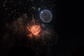 Multiple Fireworks in night sky in a composition in shades orange and white