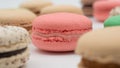 Multiple flavor Cake macaron or macaroon on turquoise macros on a white background