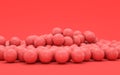 Multiple football balls in flat monochrome red scene, single color, 3d rendering Royalty Free Stock Photo