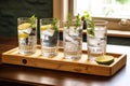 multiple glasses of gin and tonic on a wooden tray