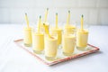 multiple glasses of mango lassi lined up for a party served with short straws Royalty Free Stock Photo