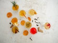 Multiple glasses with a variety of kombucha flavors on a white background