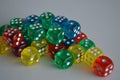 Multiple green yellow purple blue red plastic arcylic d6 six sided die dice variable focus Royalty Free Stock Photo