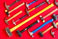 Multiple hammers on a vivid red background