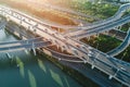 Aerial view of multiple highways intersect above a calm river, surrounded by vibrant greenery. Royalty Free Stock Photo