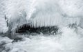 Multiple icicles on mountain river, in hard winter Royalty Free Stock Photo