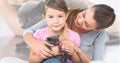 Multiple image of cute black kitten and caucasian mother and daughter holding black kitten