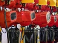 Multiple industrial hoists in a workshop ready for heavy lifting and transport activities during daytime operations Royalty Free Stock Photo