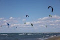 Multiple kitesurfers enjoying active sports holiday at windy Mediterranean sea waves Royalty Free Stock Photo