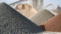 Large piles of various construction aggregates like gravel sand and crushed stone at an industrial processing facility Royalty Free Stock Photo