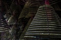 Multiple large yellow incense coils hanging in stacks from the Ceiling in a Chinese shrine